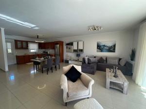 a living room with a couch and a table at Chrysa's Luxury Apt. View of Palamidi in Nafplio