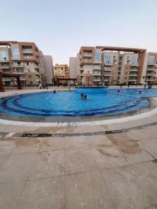 a large pool of water in a large building at Stylish 3 bedroom apartment close to the Pyramids and Grand Egyptian Museum in ‘Ezbet `Abd el-Ḥamîd