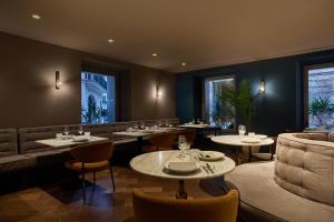 a restaurant with tables and chairs and a couch at Sant Jaume Design Hotel in Palma de Mallorca