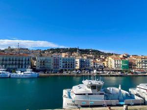 a large boat is docked in a harbor at ''Georgio'' Grand appartement traversant avec vue canal et parking in Sète