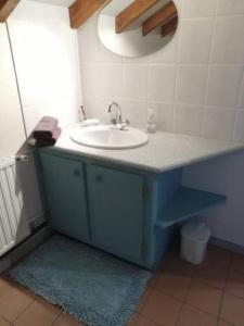 a bathroom with a sink and a blue cabinet at Chambres d'hôtes Hébergement F.Mathieu in Saint-Maurice-sur-Moselle