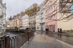 a city street in the rain with buildings at Deluxe 2BDRs Home in Spa District Center in Karlovy Vary