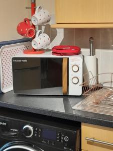 a microwave sitting on top of a kitchen counter at Shakespeare in Measham