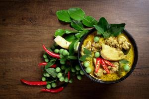 a bowl of food with a bunch of green vegetables at Maehaad Garden Inn in Mae Haad