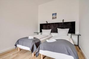 Postel nebo postele na pokoji v ubytování Apartamenty Mickiewicza - Superior Suites Katowice