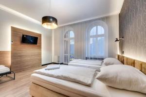Postel nebo postele na pokoji v ubytování Apartamenty Mickiewicza - Superior Suites Katowice