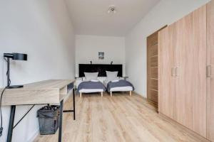 Postel nebo postele na pokoji v ubytování Apartamenty Mickiewicza - Superior Suites Katowice