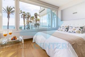 a bedroom with a bed with a view of the ocean at Malaga Center Flat Exclusive in Málaga