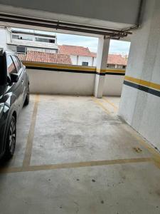 a parking lot with a car parked in a garage at Mar & Descanso Itaparica in Vila Velha