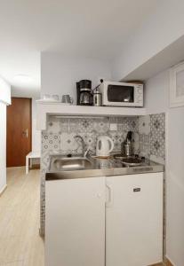 uma cozinha com um lavatório e um micro-ondas em Downtown Studio Thessaloniki em Tessalônica