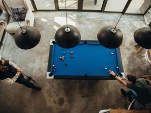 a group of people playing a game of pool at Sensiri Myst Country House in Dullstroom