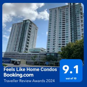 two tall buildings in a city with the words feels like home condos at Feels Like Home Condos Abreeza Place Tower 1 & 2 in Davao City