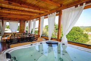 a hot tub in a house with a view at Cozy and Chic Little House with pool Ivinj - 4 in Tisno
