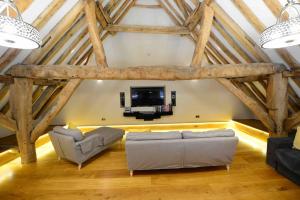 a living room with two couches and a tv at Forest Farm Barn Hampshire in Bishops Waltham