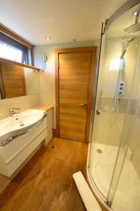 a bathroom with a glass shower and a sink at Forest Farm Barn Hampshire in Bishops Waltham