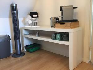 a white shelf with a coffee maker on it at Sunny dunes in Zandvoort