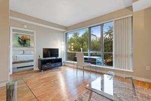 a large living room with a bed and a large window at Global Luxury Suites San Jose Downtown in San Jose