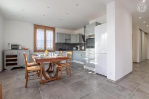 a kitchen with a table and chairs in a kitchen at Chez nicole et alain in Ugine +22 photos