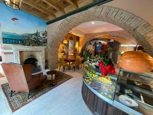 a large room with a counter with a fireplace at Hotel 99 Cannelle in LʼAquila