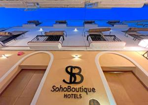 un cartello per un hotel boutique con tre posti letto di Soho Boutique Cádiz a Cadice