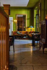 a living room with a couch and a table at Hotel Schimmelpenninck Huys in Groningen +18 photos