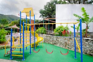 un parque infantil con un tobogán amarillo y azul en Hotel La Pedregosa, en Mérida