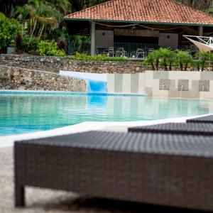 a swimming pool with a slide in the middle at Hotel La Pedregosa in Mérida +24 photos