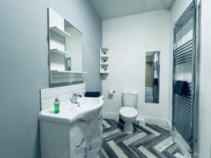 a white bathroom with a sink and a toilet at Jacksons Modern Retreat Close to Tynemouth in Tynemouth