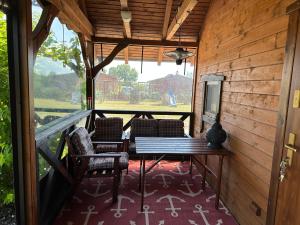 a screened in porch with a table and chairs at Luxdomki Kąty Rybackie in Kąty Rybackie