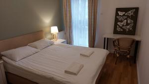 Posteľ alebo postele v izbe v ubytovaní Apartament Robinia z miejscem parkingowym