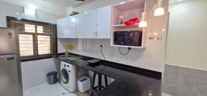 a kitchen with a sink and a washer and dryer at Tony's Inn Baga Apartment in Baga