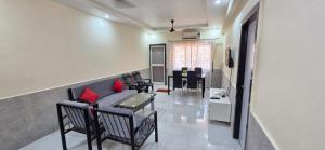 a living room with a couch and a table at Tony's Inn Baga Apartment in Baga