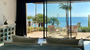 a bedroom with a bed and a view of the ocean at El jardin Botánico Villa LUZ in Altea