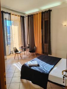 a bedroom with a bed and a table and chairs at B&B Piazza Ragusa in Rome