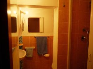 a bathroom with a sink and a toilet and a mirror at Casa Vacanza Apollo in Siracusa