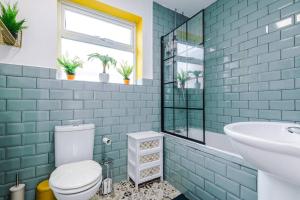 a bathroom with a toilet and a sink at Seaside Serenity: Coastal Charm in Rhyl