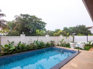 a swimming pool in the backyard of a house at Jade 4BHK Private Pool Duplex by Le Pension Stays in Old Goa +20 photos