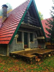 a house with a red roof with a ramp in front at Woodland Cosy ‘Secret’ Villa in the beauty Osogovo Mountain in Lesnovo