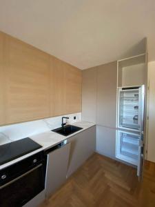 a small kitchen with a sink and a refrigerator at Bratislava FORESTPARK, FREE parking, self-check IN in Bratislava