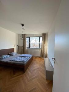a bedroom with a large bed and a window at Bratislava FORESTPARK, FREE parking, self-check IN in Bratislava