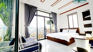 a bedroom with a bed and a balcony at Khách Sạn - Homestay Canary Bảo in Phan Thiet +148 photos