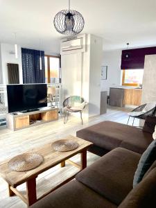 a living room with a couch and a table at Baltic Sands in Hel