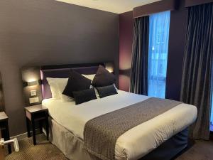 a bedroom with a bed with pillows and a window at Tunnage Square Apartments Duke St by EPIC in Liverpool