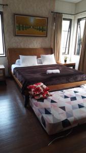 Giường trong phòng chung tại Vila Princess. Vimalla hills 3br+1br Privatepool, minigolf, ayunan besar, bbq