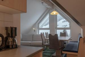 eine Küche und ein Wohnzimmer mit einem Tisch und einem Sofa in der Unterkunft Petit madlein in Ischgl