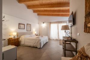 a hotel room with a bed and a window at Dimoras Boutique Rooms in Olbia