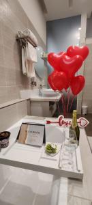 a room with red balloons and a table with a box at Afrodite Guest House in Caserta