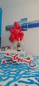 a group of red balloons and a pair of scissors at Afrodite Guest House in Caserta