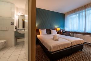 Postel nebo postele na pokoji v ubytování Hotel Docklands Antwerpen