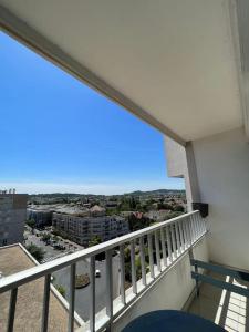 a balcony with a view of a city at Superbe appartement meublé avec parking in Saint-Gratien